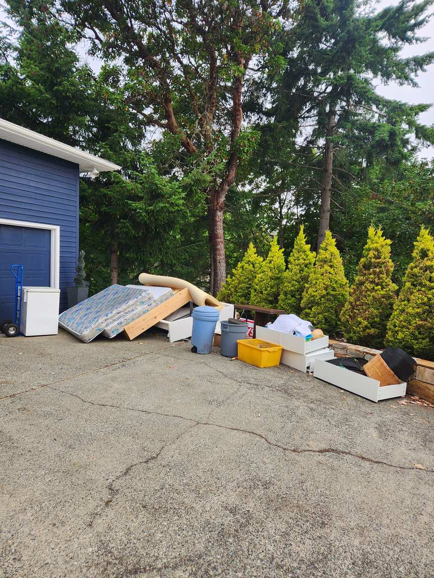 A Nanaimo driveway cleared of a mattress, freezer, drawers and bins by Junk Matters