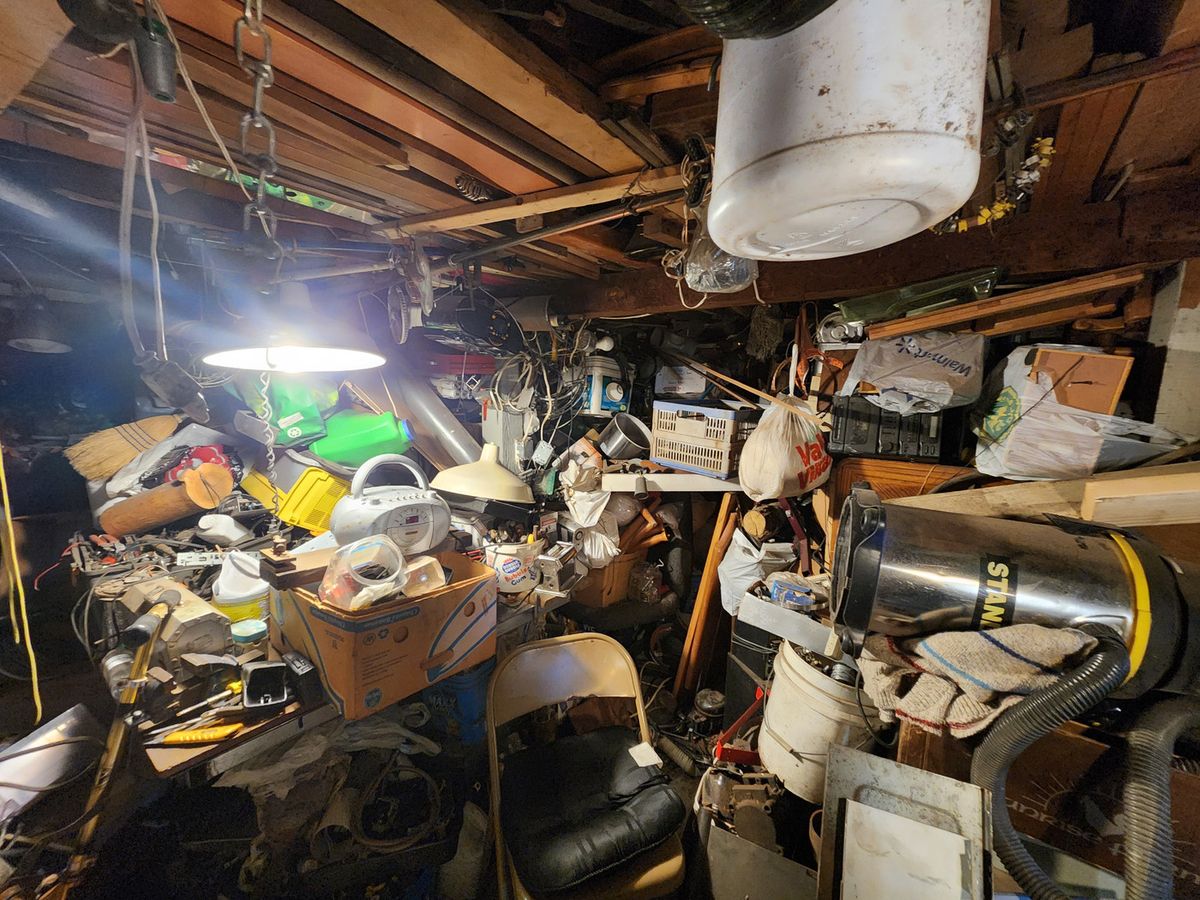 A packed basement in Nanaimo before a Junk Matters hoarder cleanout