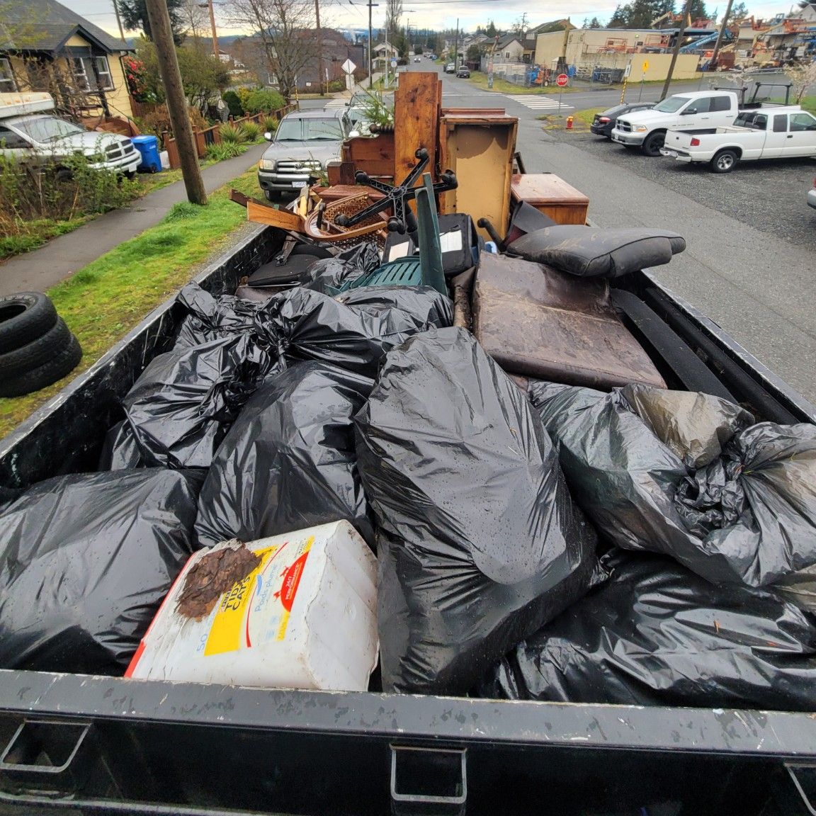 A real full load: bags, furniture and cushions level with the sides of the Junk Matters trailer