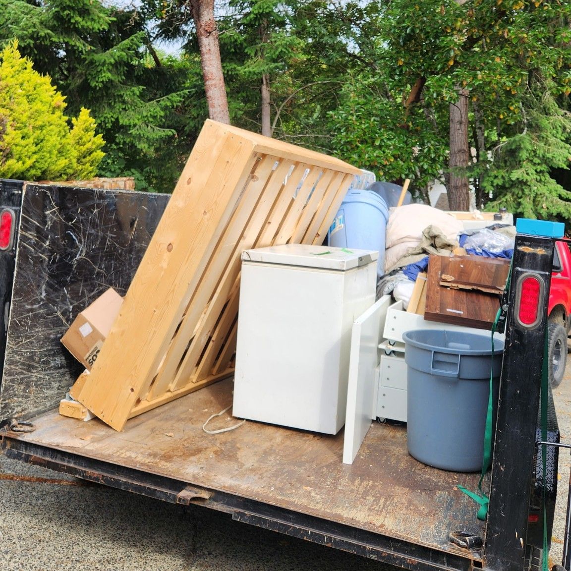 A real three-quarter load: bed frame, freezer and furniture filling most of the Junk Matters trailer