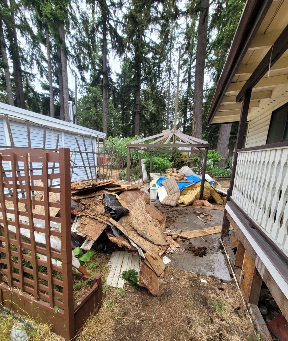 Backyard patio in Cassidy piled with post-renovation debris before cleanup