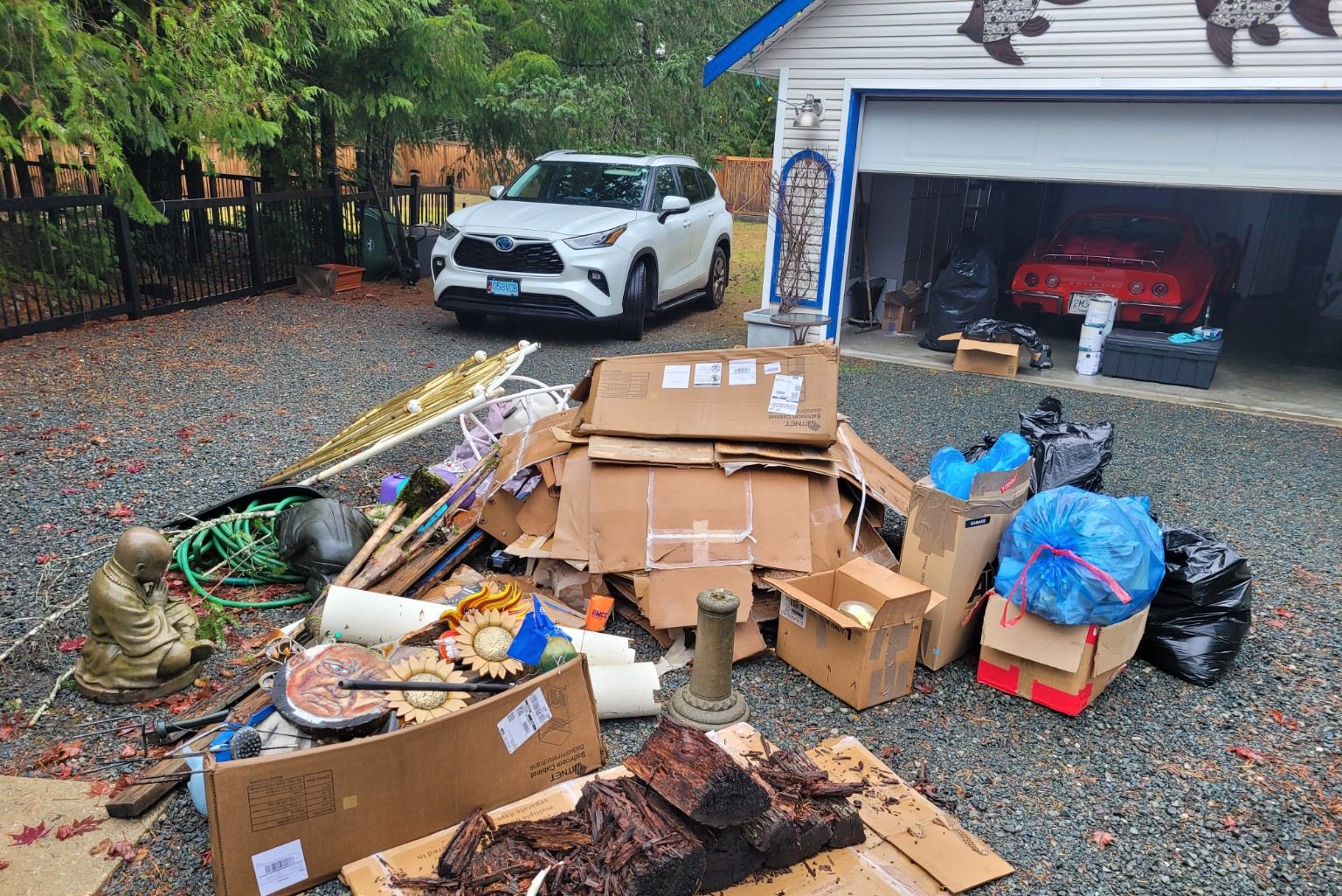 Flattened cardboard boxes and packing material stacked in a Ladysmith area driveway before pickup
