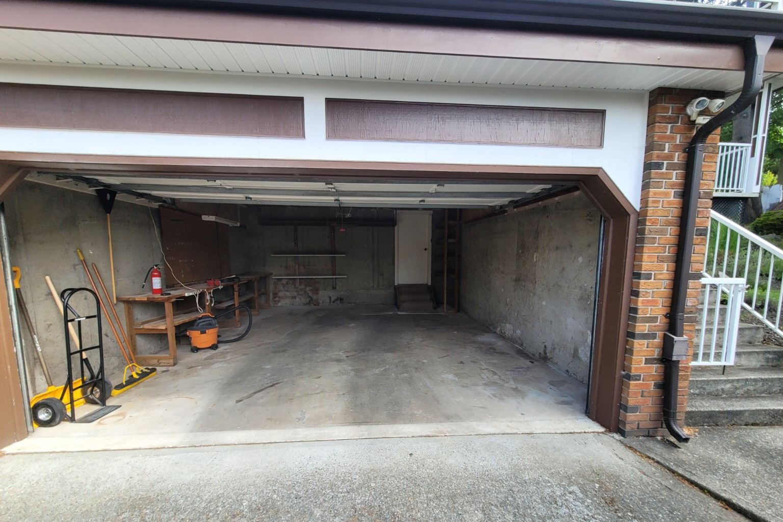 A clean empty two-car garage after the cleanout