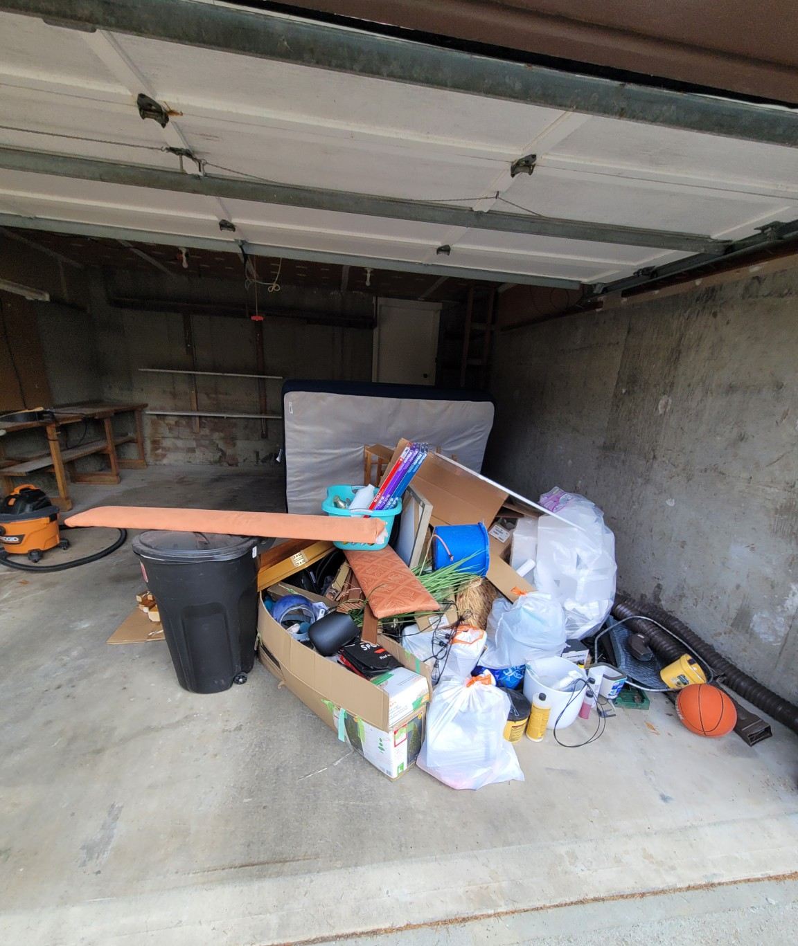 Garage bay on Smugglers Hill piled with junk before a cleanout