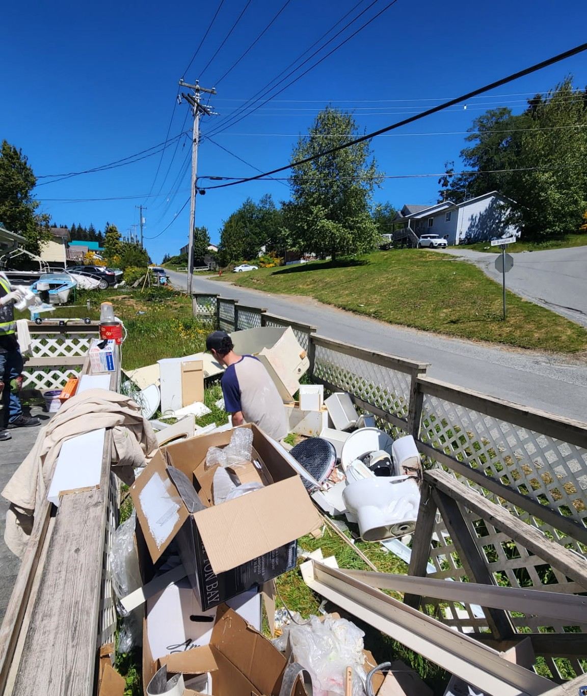 Renovation debris and building leftovers piled across a Parksville lawn before pickup
