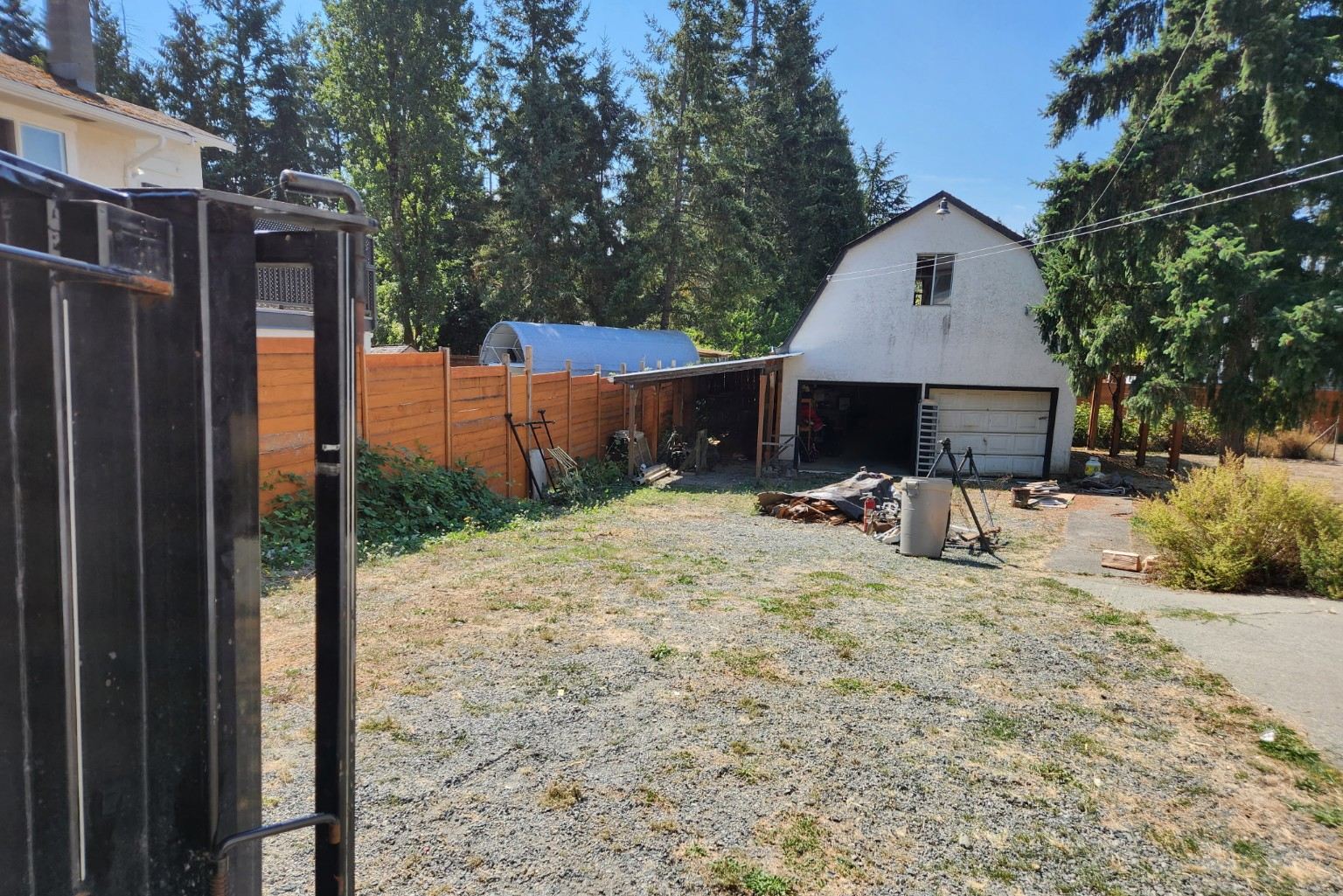 The same carport-side area in Nanaimo cleared down to clean gravel after Junk Matters hauled the pile away