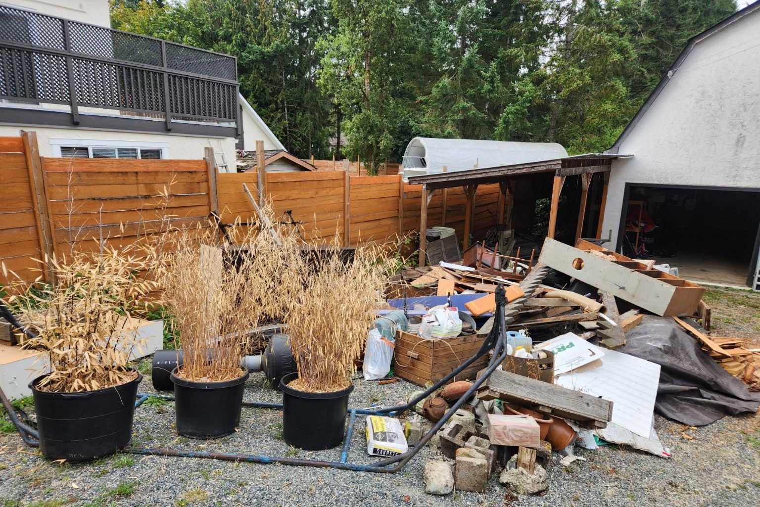 A pile of branches, wood and yard debris stacked beside a carport in Nanaimo before removal
