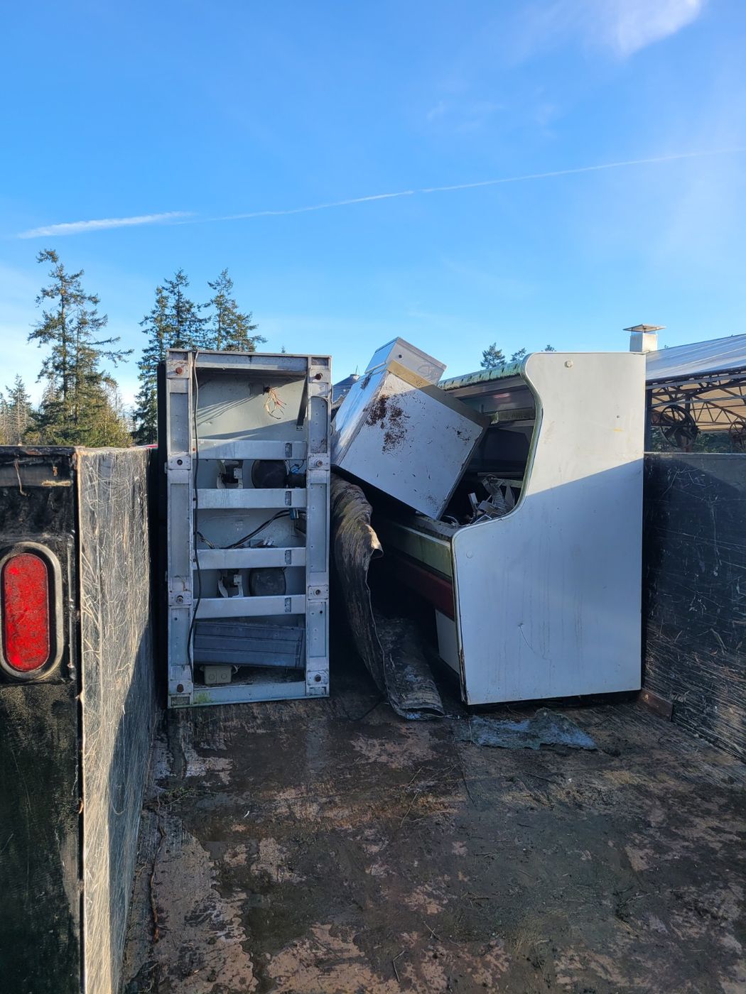 Appliances and metal shelving loaded upright inside the Junk Matters trailer in Nanaimo