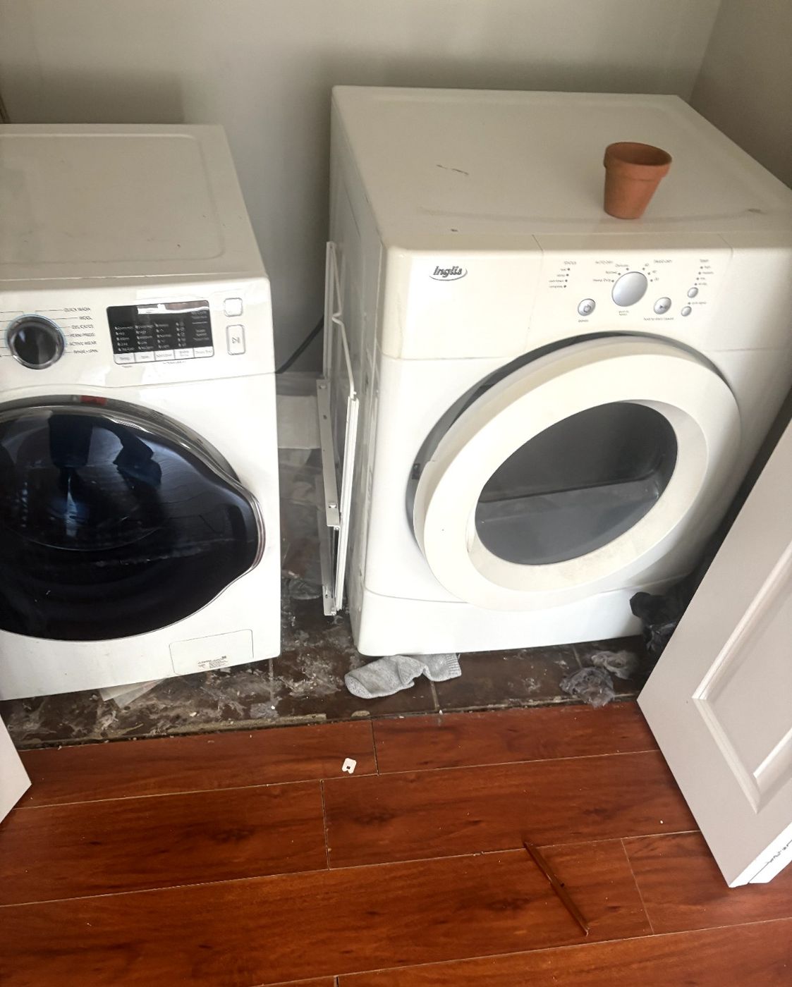 A front-loading washer and dryer pair standing in a Nanaimo laundry room before Junk Matters removed them