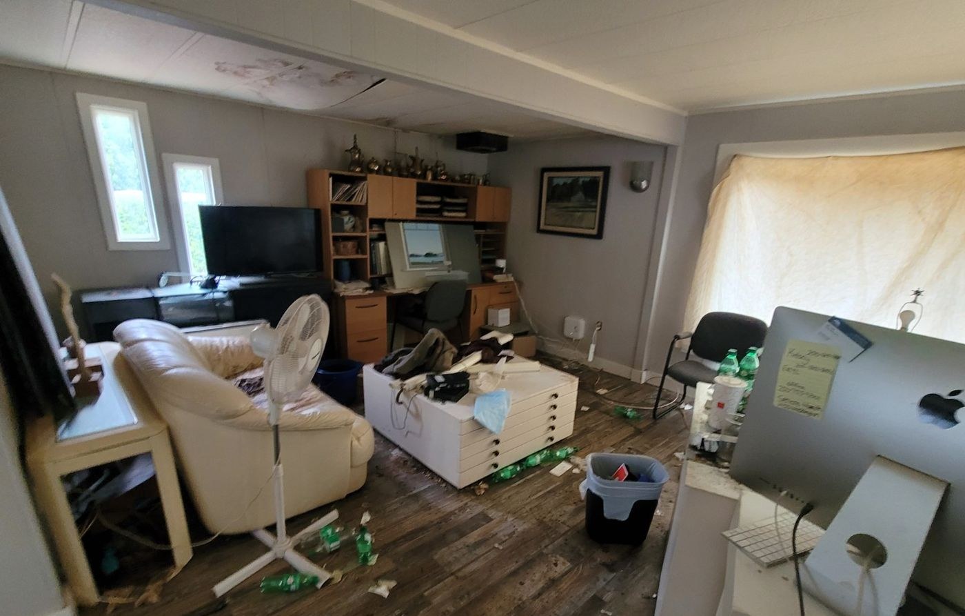 A Nanaimo living room part way through an estate cleanout with furniture, boxes and belongings still in place