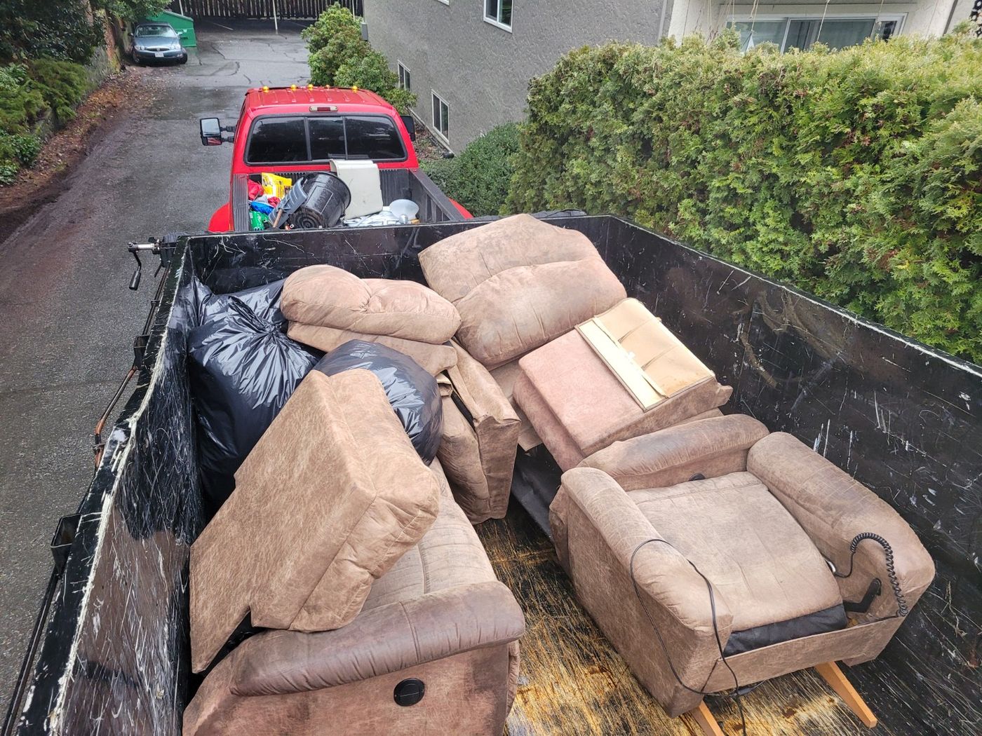 The same recliners and sofa cushions stacked inside the Junk Matters trailer in Nanaimo after loading