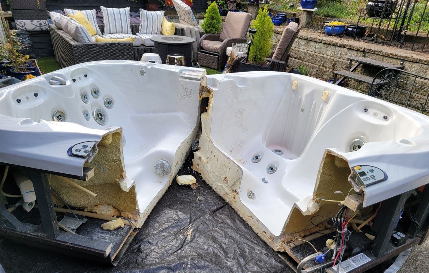 A hot tub cut into two halves on a Nanaimo patio, ready to be carried out piece by piece