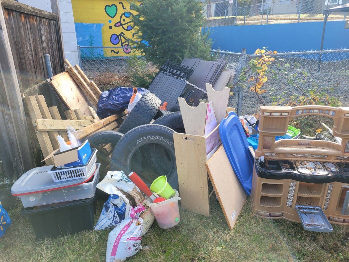 A pile of totes, toys, cardboard and a tire cleared out of a Nanaimo garage onto the lawn