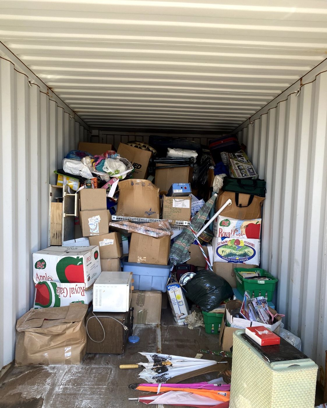 A storage unit packed wall to wall with boxes, totes and household goods before a Junk Matters cleanout in Nanaimo